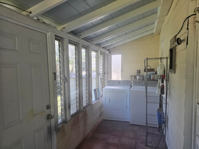 laundry room featuring dark tile patterned floors, wood ceiling, and washer and dryer