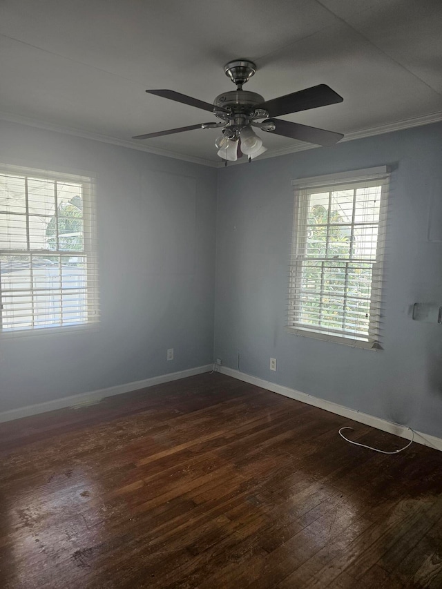 unfurnished room featuring dark wood-type flooring, ceiling fan, ornamental molding, and a healthy amount of sunlight