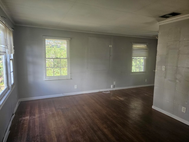 spare room with dark hardwood / wood-style floors and crown molding