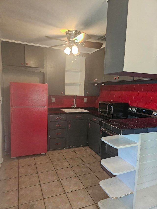 kitchen featuring tile countertops, white refrigerator, light tile patterned floors, tasteful backsplash, and ventilation hood