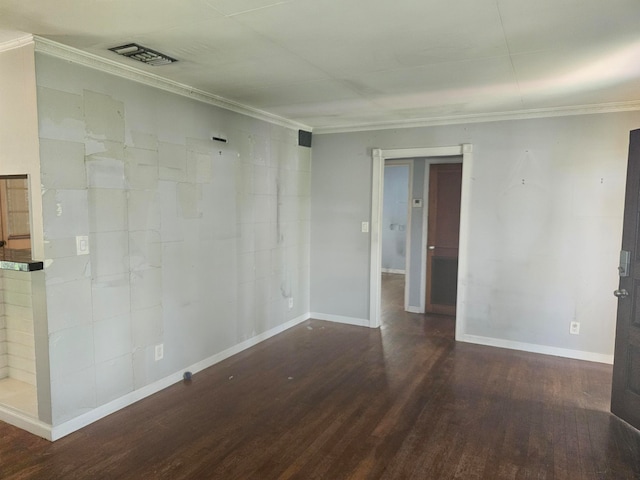 unfurnished room featuring dark wood-type flooring and ornamental molding