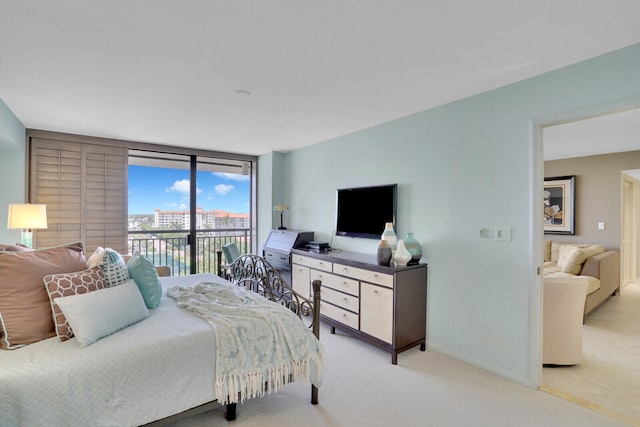 bedroom featuring light carpet and access to outside