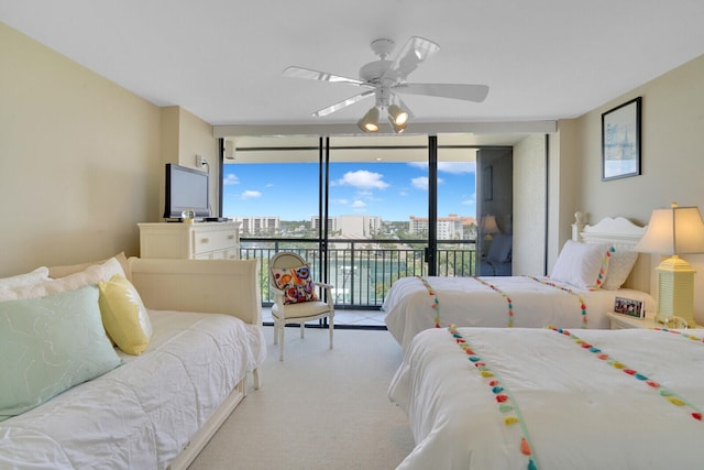 bedroom featuring floor to ceiling windows, ceiling fan, light carpet, and access to exterior