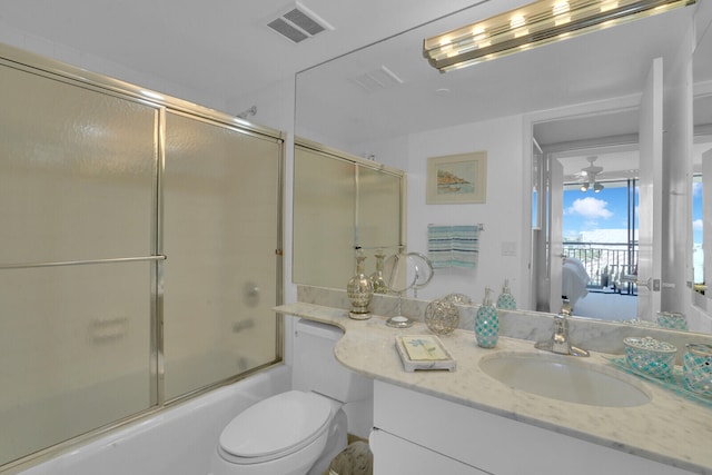 full bathroom with vanity, ceiling fan, combined bath / shower with glass door, and toilet