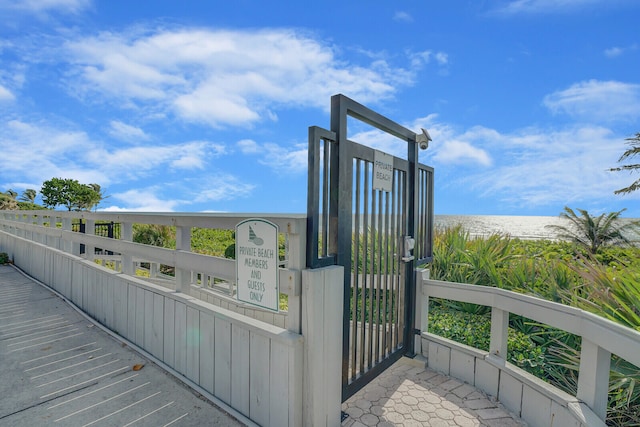 exterior space featuring a water view and a beach view