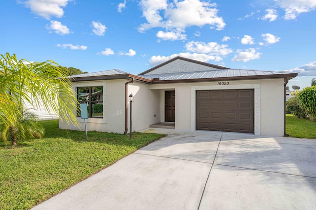 15093 Aguila Ave, Fort Pierce, FL 34951 - view of front facade featuring a front lawn and a garage