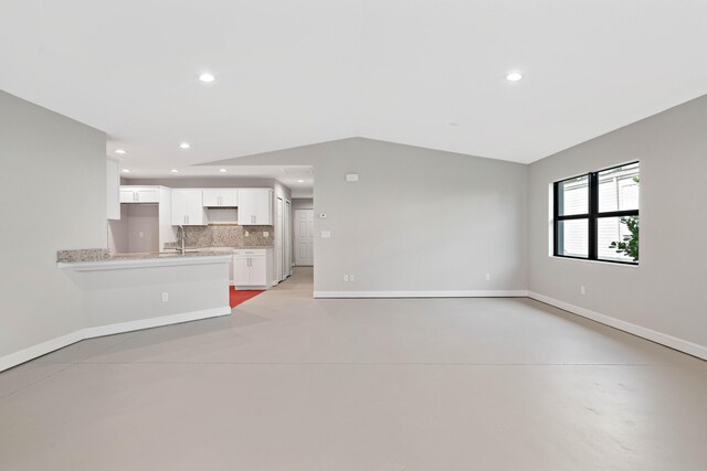 15093 Aguila Ave, Fort Pierce, FL 34951 - unfurnished living room with lofted ceiling and sink
