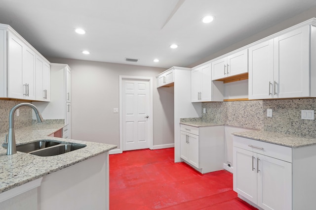 15093 Aguila Ave, Fort Pierce, FL 34951 - kitchen featuring backsplash, white cabinetry, sink, and light stone counters