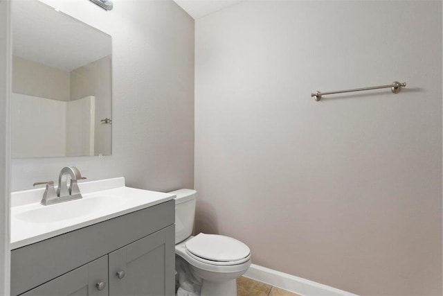 bathroom with vanity, tile patterned flooring, and toilet