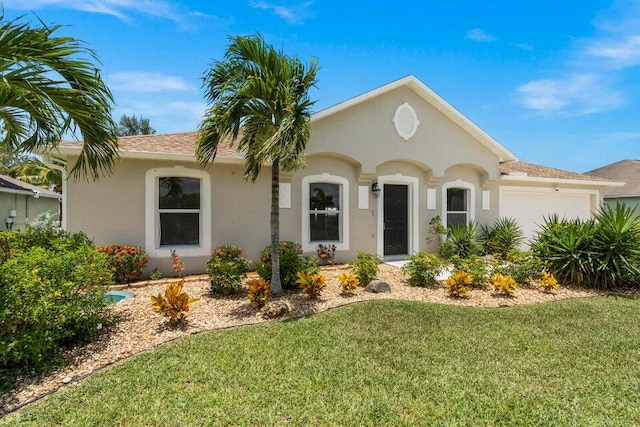 view of front of home featuring a garage and a front yard