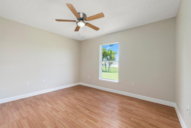 unfurnished room with a textured ceiling, ceiling fan, and light hardwood / wood-style flooring