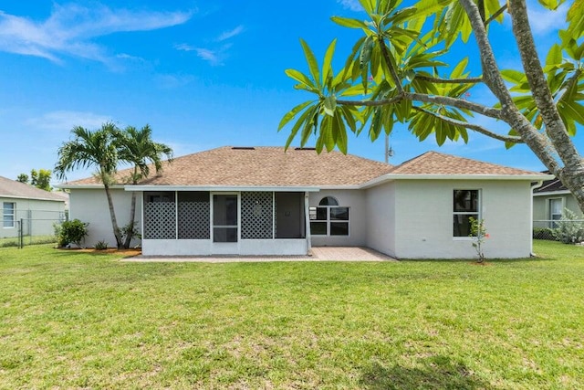 rear view of property with a yard