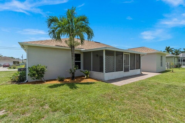 back of house featuring a sunroom and a yard