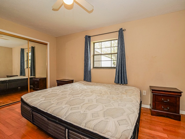 bedroom featuring hardwood / wood-style flooring, a closet, and ceiling fan