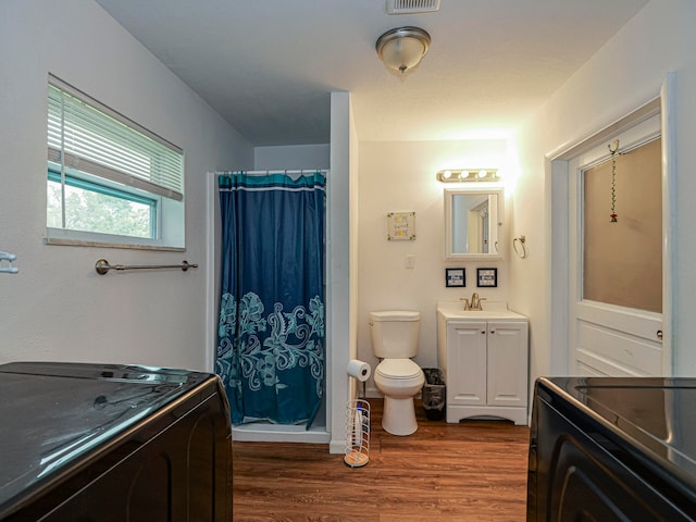 bathroom featuring a shower with curtain, vanity, toilet, and wood-type flooring