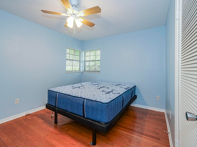 bedroom featuring dark hardwood / wood-style floors and ceiling fan