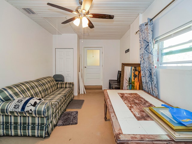 interior space with ceiling fan