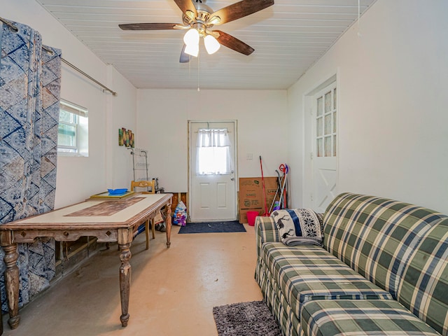 living room featuring concrete floors, a wealth of natural light, and ceiling fan