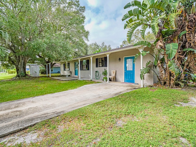 ranch-style home with a front lawn