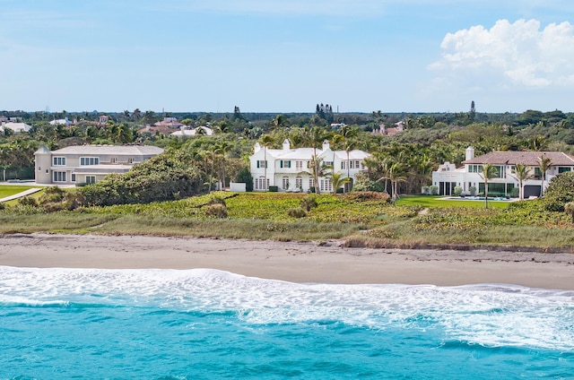 view of swimming pool featuring a view of the beach and a water view