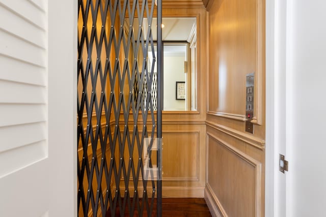 room details featuring a decorative wall and elevator