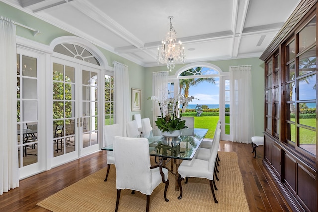 dining area with french doors, dark hardwood / wood-style flooring, an inviting chandelier, and coffered ceiling