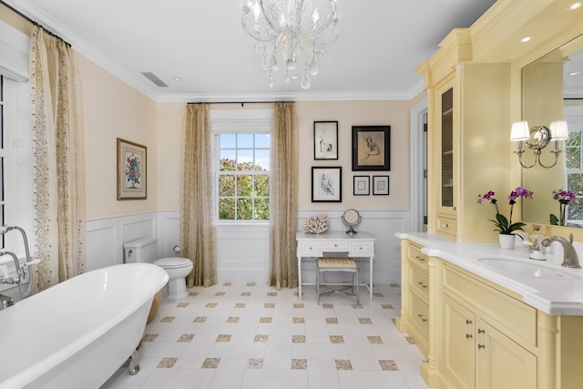 bathroom with ornamental molding, a wainscoted wall, vanity, and an inviting chandelier