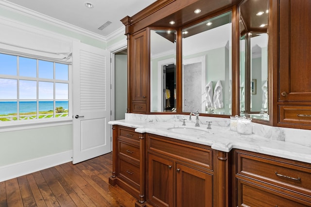 bathroom featuring crown molding, visible vents, a water view, vanity, and hardwood / wood-style floors