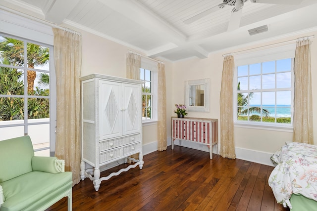 bedroom featuring hardwood / wood-style flooring, visible vents, baseboards, ornamental molding, and beam ceiling