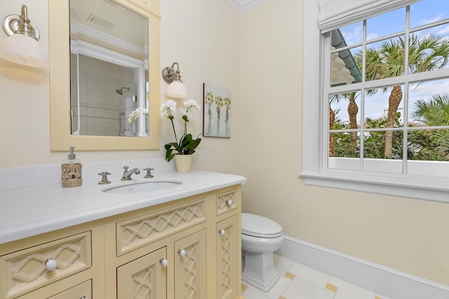 full bath featuring baseboards, vanity, toilet, and walk in shower