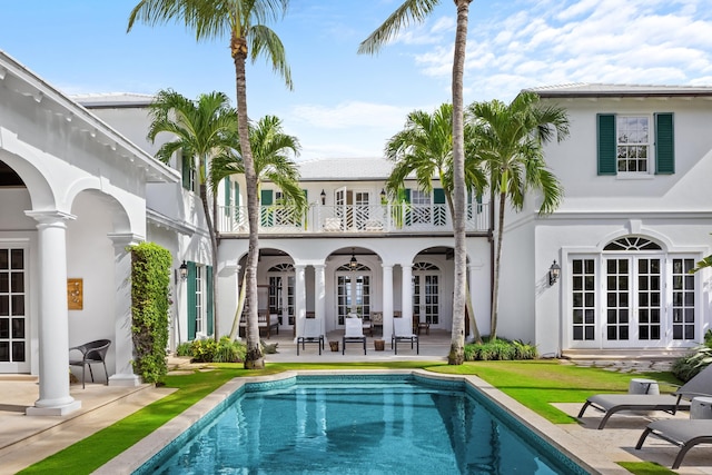 back of house featuring french doors, a patio, and a balcony