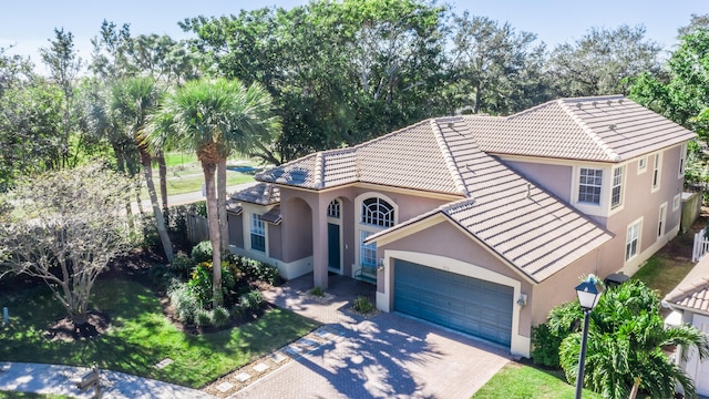 mediterranean / spanish-style home with a garage