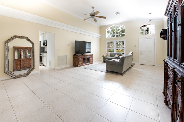 living room featuring ceiling fan, light tile patterned floors, crown molding, and lofted ceiling