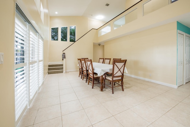 tiled dining space with high vaulted ceiling