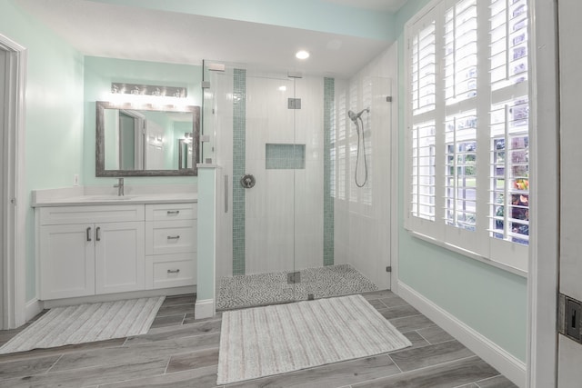 bathroom featuring vanity and an enclosed shower