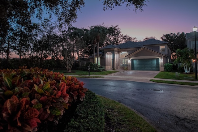 view of front of property with a yard and a garage