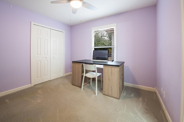 office space featuring ceiling fan and light colored carpet