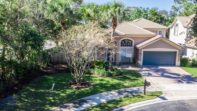 mediterranean / spanish-style house with a front lawn and a garage