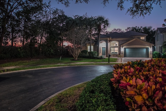 view of front of property with a lawn and a garage