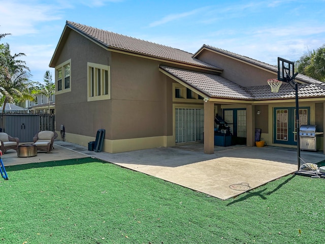 rear view of property with a yard and a patio