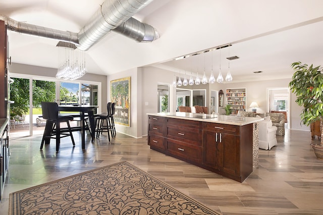 kitchen featuring hanging light fixtures, a center island, black electric cooktop, and a wealth of natural light