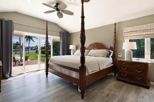 bedroom with access to exterior, ceiling fan, wood-type flooring, and vaulted ceiling