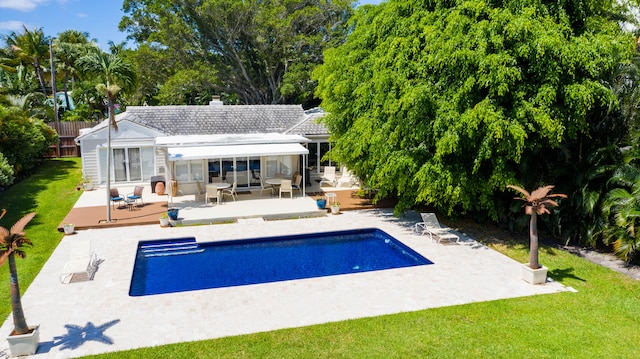 view of swimming pool with a lawn and a patio area