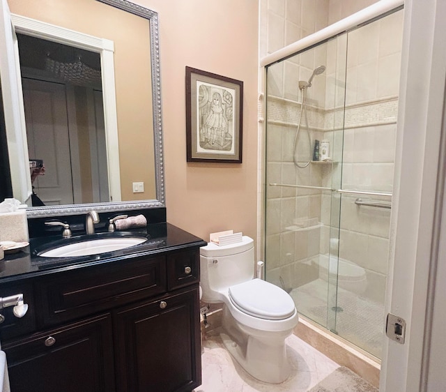 bathroom featuring toilet, vanity, and walk in shower