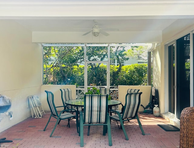 sunroom featuring ceiling fan