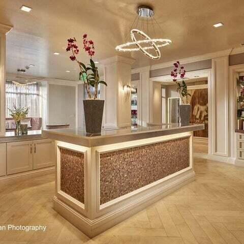 welcome area featuring a chandelier and decorative columns