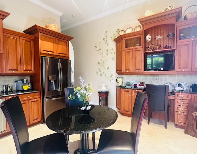 kitchen featuring ornamental molding, stainless steel refrigerator with ice dispenser, and decorative backsplash