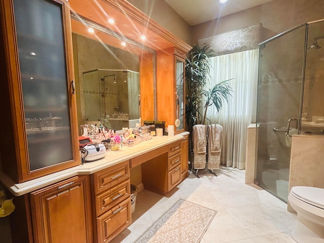 bathroom with tile patterned flooring, an enclosed shower, vanity, and toilet