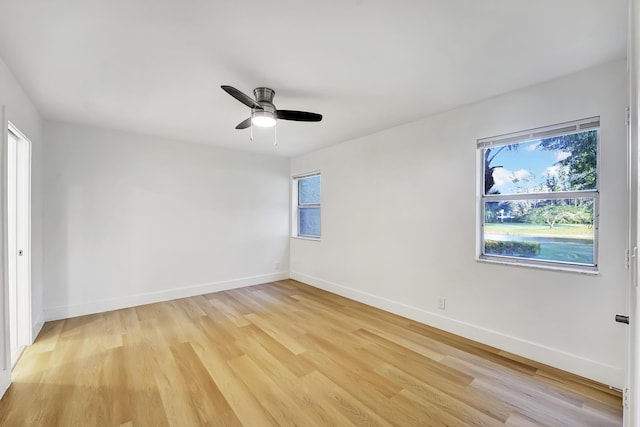 empty room with light hardwood / wood-style flooring, plenty of natural light, and ceiling fan