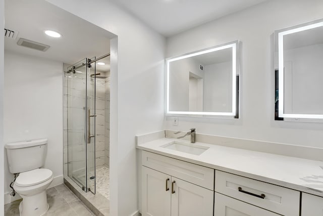 bathroom with tile patterned flooring, a shower with door, vanity, and toilet